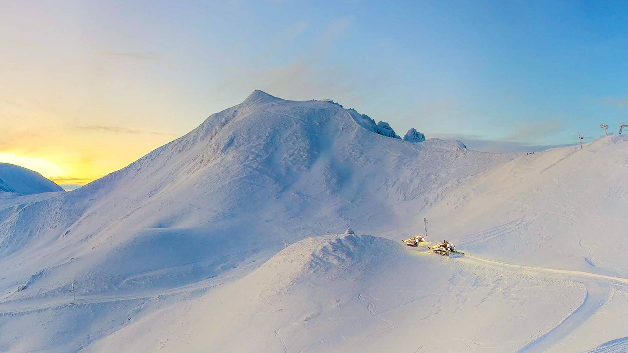 Snow groomers at the snow-covered Sancy Summit